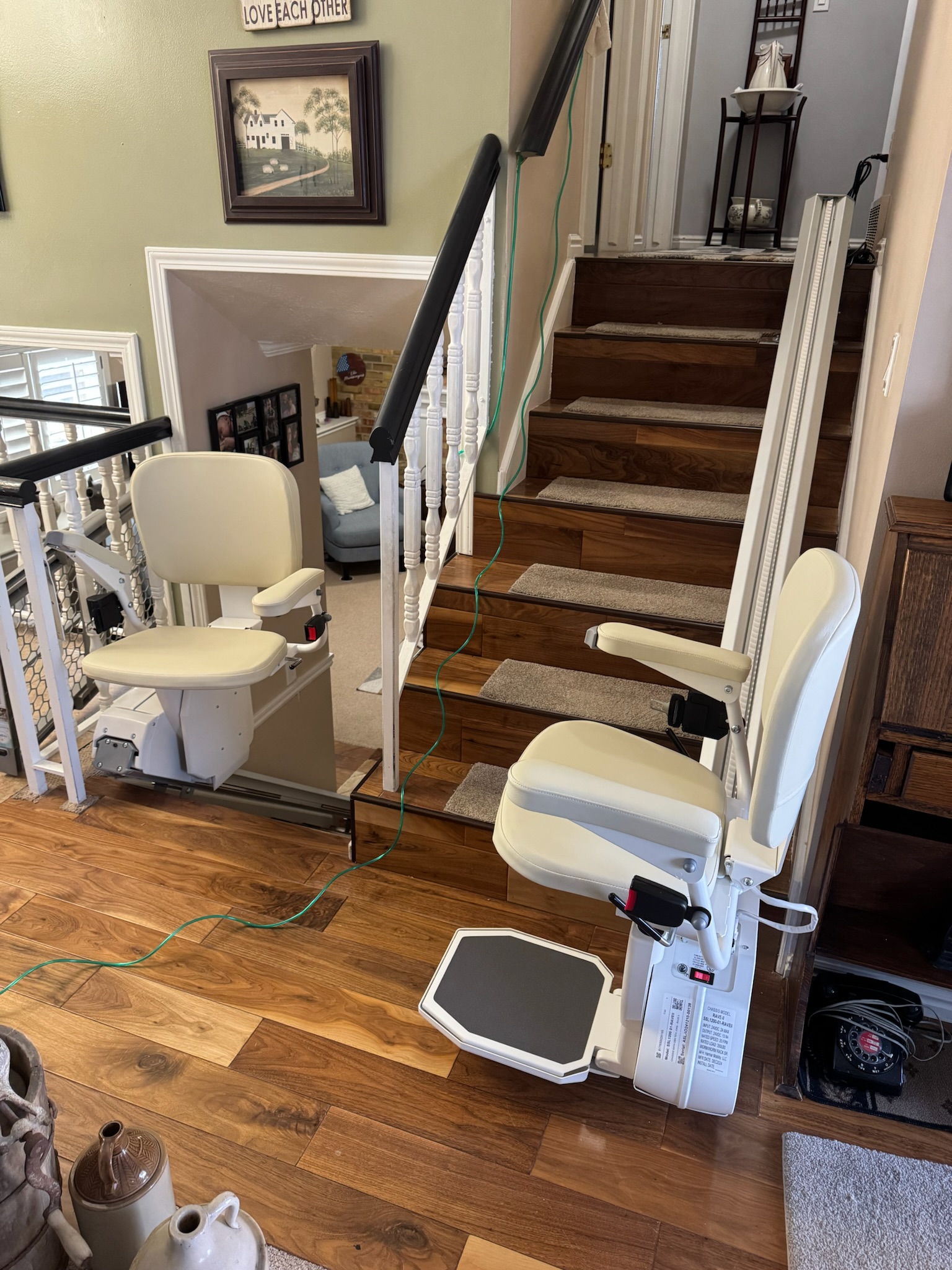 Two straight stairlifts installed on a residential staircase